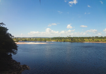 Canaima National Park in Venezuela – Vegetation, lagoon views, and a beautiful blue sky with large clouds