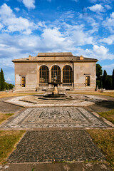 Fototapeta premium Renaissance villa courtyard with stone fountain and decorative mosaic pathway
