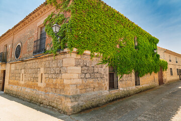 Urueña, Valladolid, Spain – View of old stone streets of the village with its church in the background.