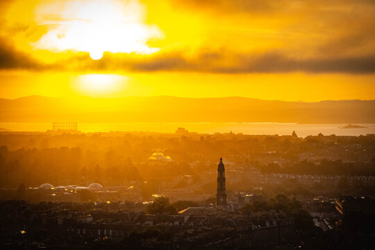sunset over edinburgh over the firth of forth, view from calton hill, edinburgh, scotland