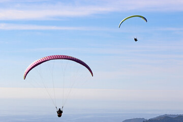 Paragliders flying above the Mediterranean coast