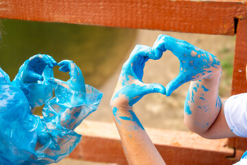 Happy couple at a baby gender reveal party. Gender party. Dad, mom T-shirt. In the photo, the hands...