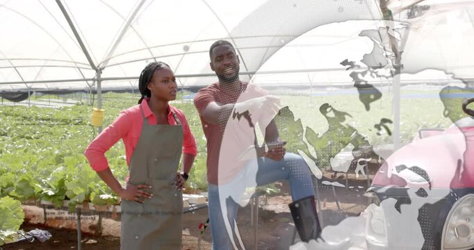 Farm manager guiding assistant swiping tablet menu and correlating soil data with greenhouse beds