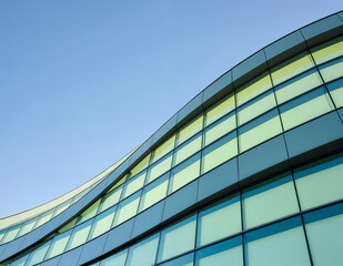 Modern Curved Building Facade with Tinted Grid Windows — Minimalist Architectural Composition