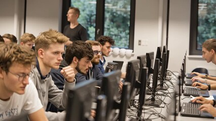 Engaged Students in Smart Classroom Focused on Technology, Computers, and Collaborative Learning in Mixed Age Group Setting - Powered by Adobe