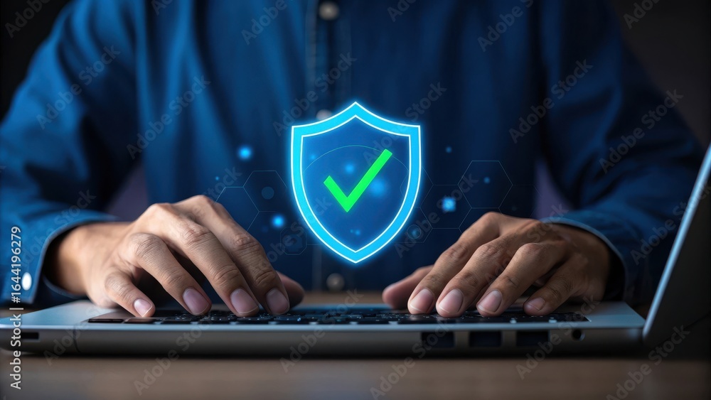 Poster person typing on a laptop with a glowing digital shield icon and checkmark symbolizing cybersecurity