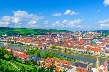 Fototapeta premium Aerial panoramic view of Wurzburg old town altstadt with Main river, green hills with vineyard, skyline horizon panorama of Wurzburg city historical center, Lower Franconia region, Germany