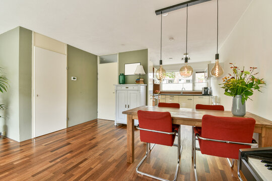 Modern Dining Area with Wooden Table and Red Chairs