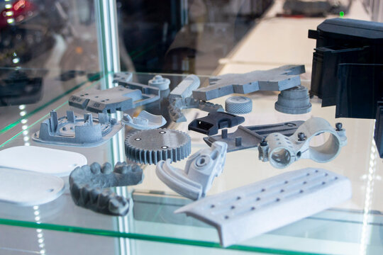 Objects printed on 3D printer from molten plastic powder. Different models printed on 3D printer from melted grey polyamide powder. Multi Jet Fusion MJF technology. New additive 3D printing technology