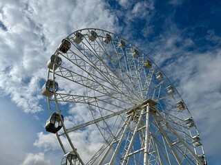 Ferris wheel on the background of blue sky in summer. High quality photo