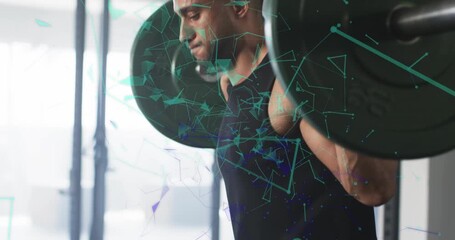 Male lifter bending under barbell in squat rack driving upward for strength with network overlay - Powered by Adobe