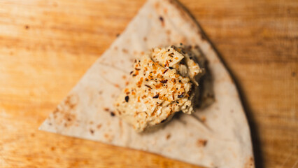 Homemade hummus with aromatic spices served on warm Syrian bread. Perfect for Mediterranean food content, vegan blogs, and restaurant menus.