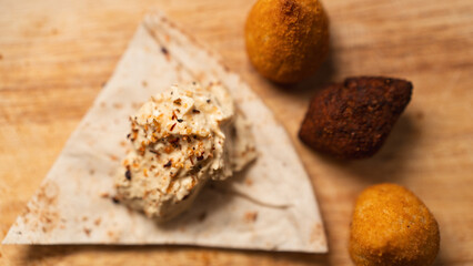 Creamy hummus with flaky chicken pastries (fatayer-style) and crispy kibbeh. Authentic Middle...
