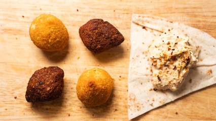 Creamy hummus with flaky chicken pastries (fatayer-style) and crispy kibbeh. Authentic Middle...