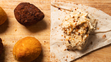 Creamy hummus with flaky chicken pastries (fatayer-style) and crispy kibbeh. Authentic Middle...