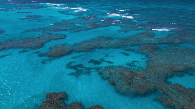 Turquoise Ocean Waves Crashing on Coral Reef, Aerial View