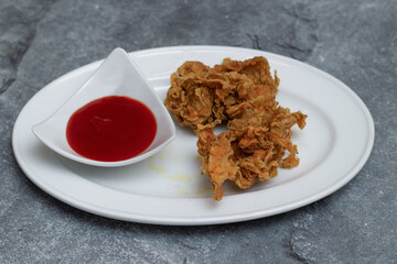 crispy fried chicken served with a side of ketchup on a white plate top view of junk food