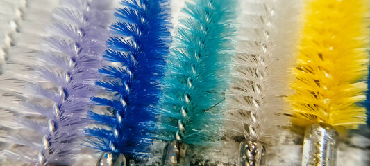 close up of colored brushes for combing eyelashes