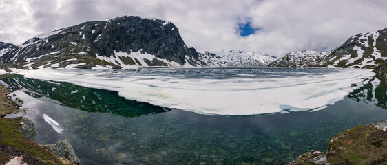 Beautiful view of Djupvatnet lake with snow near Gerainger (Norway)