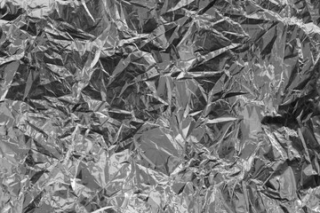 Silver crumpled foil texture on flat surface