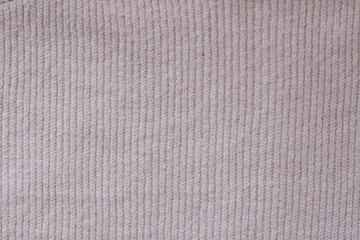 Texture of knitted pastel pink sweater, close-up texture of beige pink