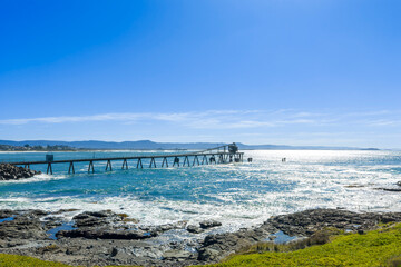 Drone aerial photograph of an old and weathered industrial loading jetty in the South Pacific Ocean...