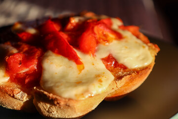 Melted cheese bruschetta with roasted tomato topping