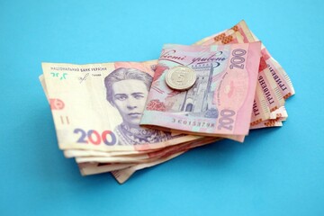 Ukrainian money bills on light blue paper background