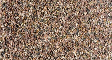 Photo of small granite stones top view.The texture of granite chips. Stone background.