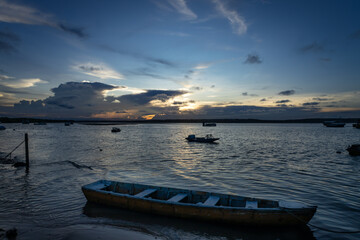 Wooden Boat at Sunset – Tranquil Coastal Scene with Fishing Vessels