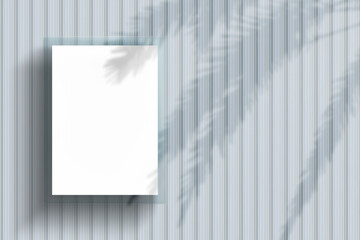 Realistic mockup of blank white poster on textured metal wall with a shadow of palm trees. Vertical...