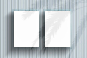 Realistic mockup of blank white poster on textured metal wall with a shadow of palm trees. Vertical...