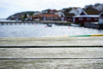Rustic Wooden Boards with Harbor and Seaside Houses in Background Blur