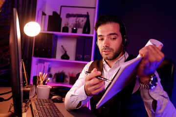 Smart businessman wearing headphones, remote meeting paperwork report folder online on pc,...