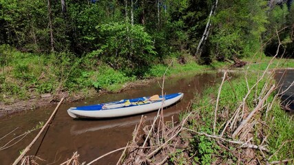 A vibrant kayak floats on calm waters, surrounded by lush greenery. This ideal spot is perfect for outdoor enthusiasts seeking adventure and tranquility while connecting with nature
