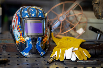 Background with welding helmet, gloves and torch. Preparation for welding steel, aluminum with flame and laser with wire on background