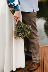 Beautiful arrangement of wedding details such as wedding rings, bridal bouquet, and elegant...
