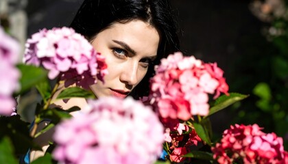 Naklejka premium Woman obscured by hydrangeas
