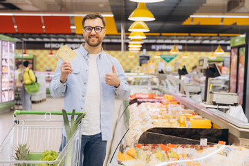Customer Showing Thumbs Up While Holding Pita Bread in Supermarket