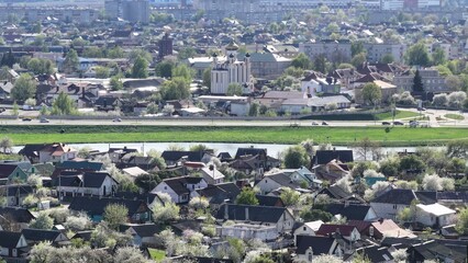 An Orthodox church rises above a town in Eastern Europe. Orthodox church, panoramic view. Modern urban housing architecture in Eastern Europe.