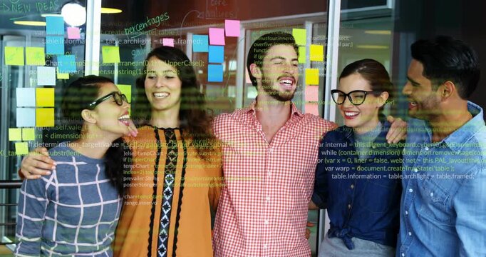 Business team placing arms around shoulders and smiling with sticky notes, holding unity pose
