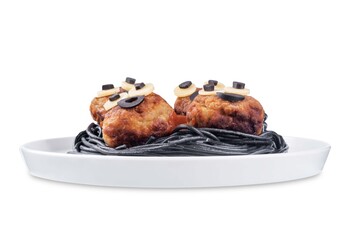 Meatballs with black pasta in the plate for Halloween on a white isolated background