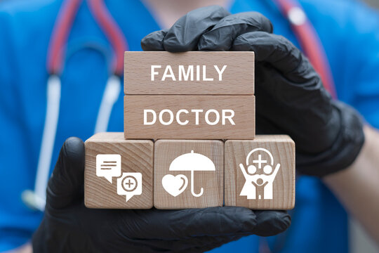 Health Care, Family Medicine and Practices concept. Physician holding wooden blocks with icons sees inscription: FAMILY DOCTOR.