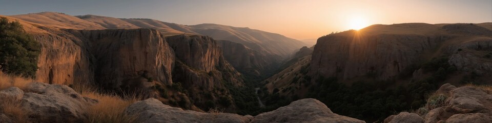 Fototapeta premium Sunset over majestic canyon landscape with rocky cliffs and rolling hills
