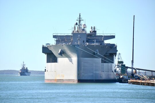 Large naval ship in port