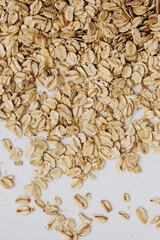 Oats scattered on a white surface ready for breakfast preparation in the morning light