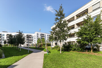 Cityscape of a residential area with modern apartment buildings, new green urban landscape in the...