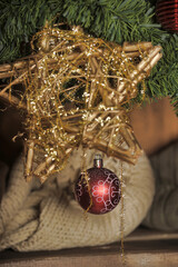a fragment of a New Year's decoration in warm, cozy tones. Against the background of fluffy fir...