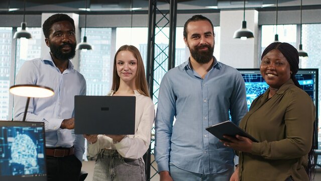 Portrait of teamworking programmers in office developing apps using AI automation. Team of smiling IT experts working on devices, debugging applications with artificial intelligence, camera A - Powered by Adobe