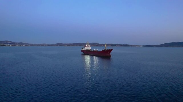 Lone cargo ship in reflective waters 4K